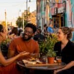 Friends exploring vibrant KC Crossroads street murals