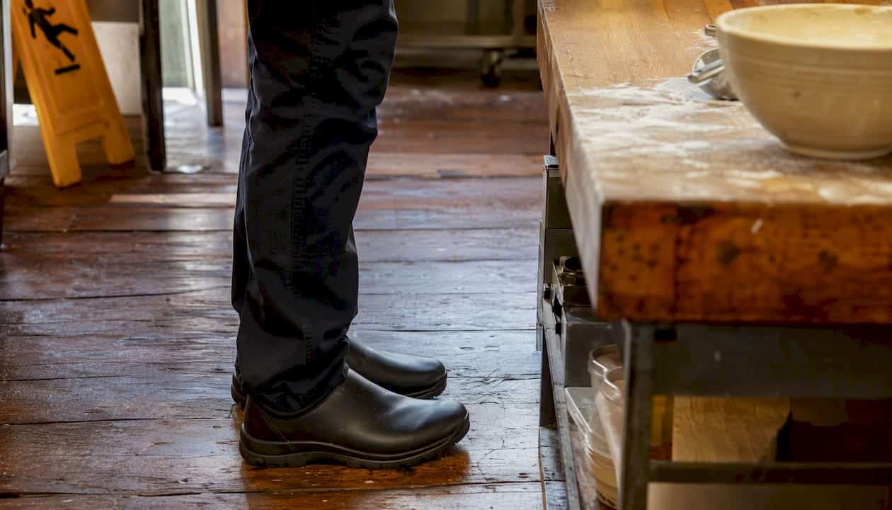 Closed-toe shoes by kitchen prep table