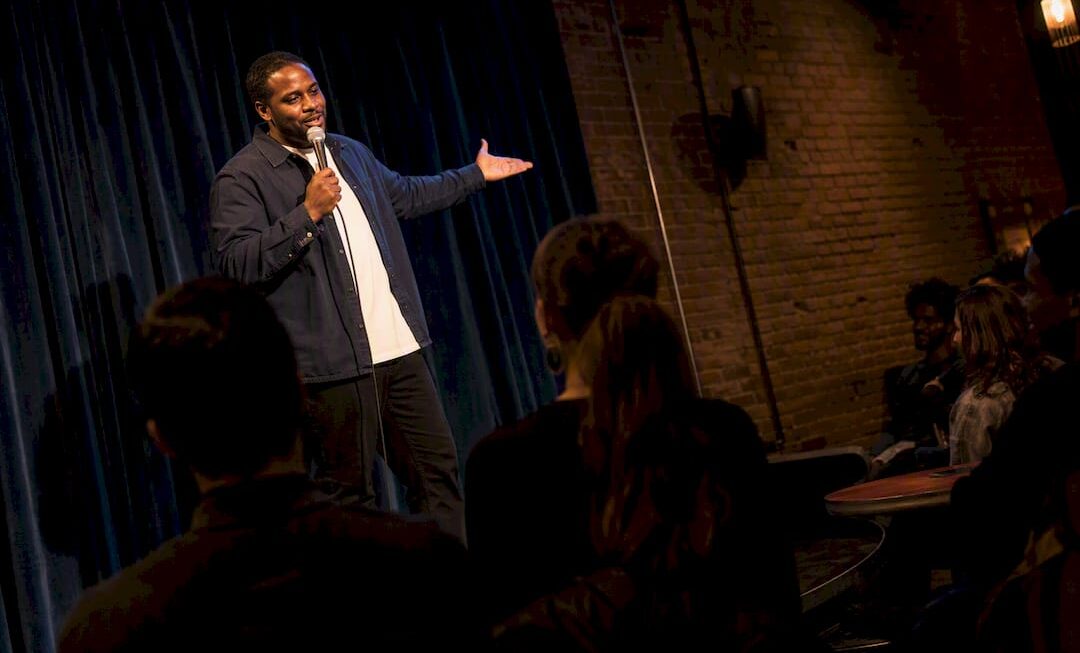 Comedian performing in an intimate Kansas City club
