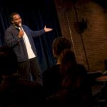 Comedian performing in an intimate Kansas City club