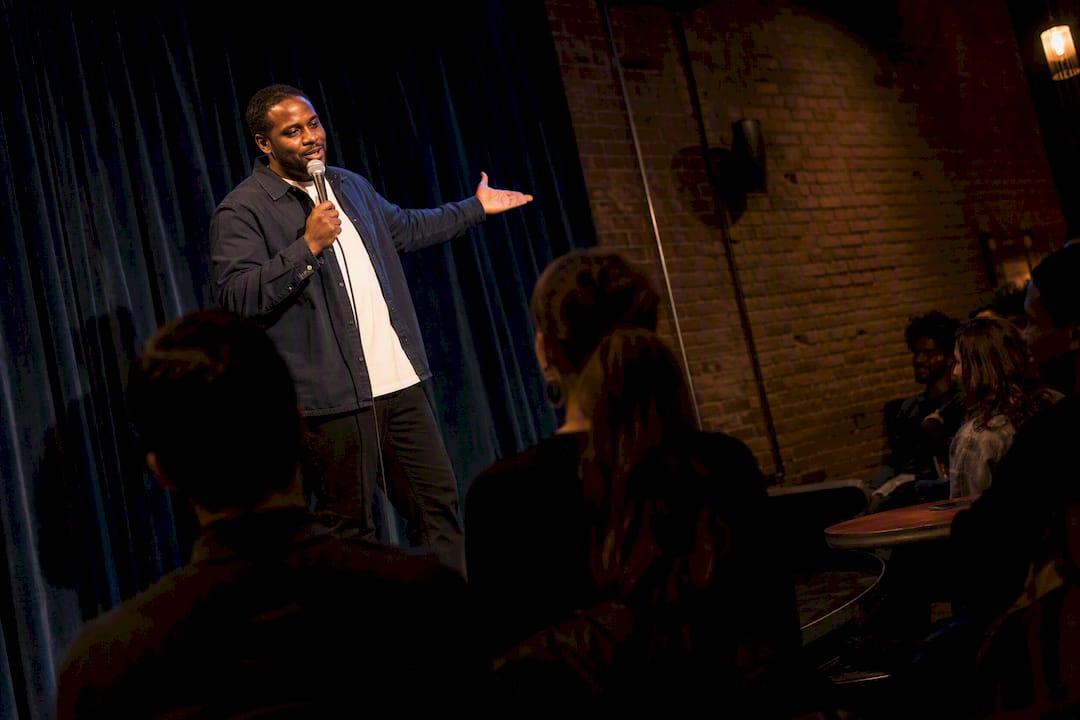 Comedian performing in an intimate Kansas City club