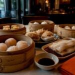 Dim sum baskets and plates on restaurant table