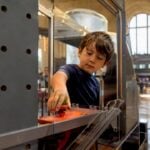 Child exploring hands-on science exhibit