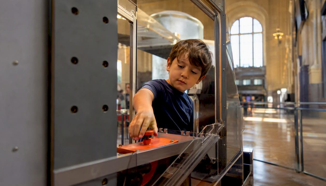Child exploring hands-on science exhibit