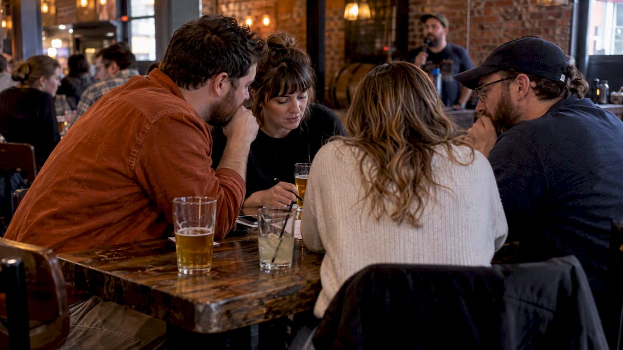 Friends debating answers at KC trivia night