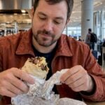 Traveler with a brisket burrito at KCI